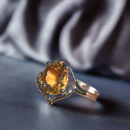 Citrine ring with diamonds displayed in indoor lighting