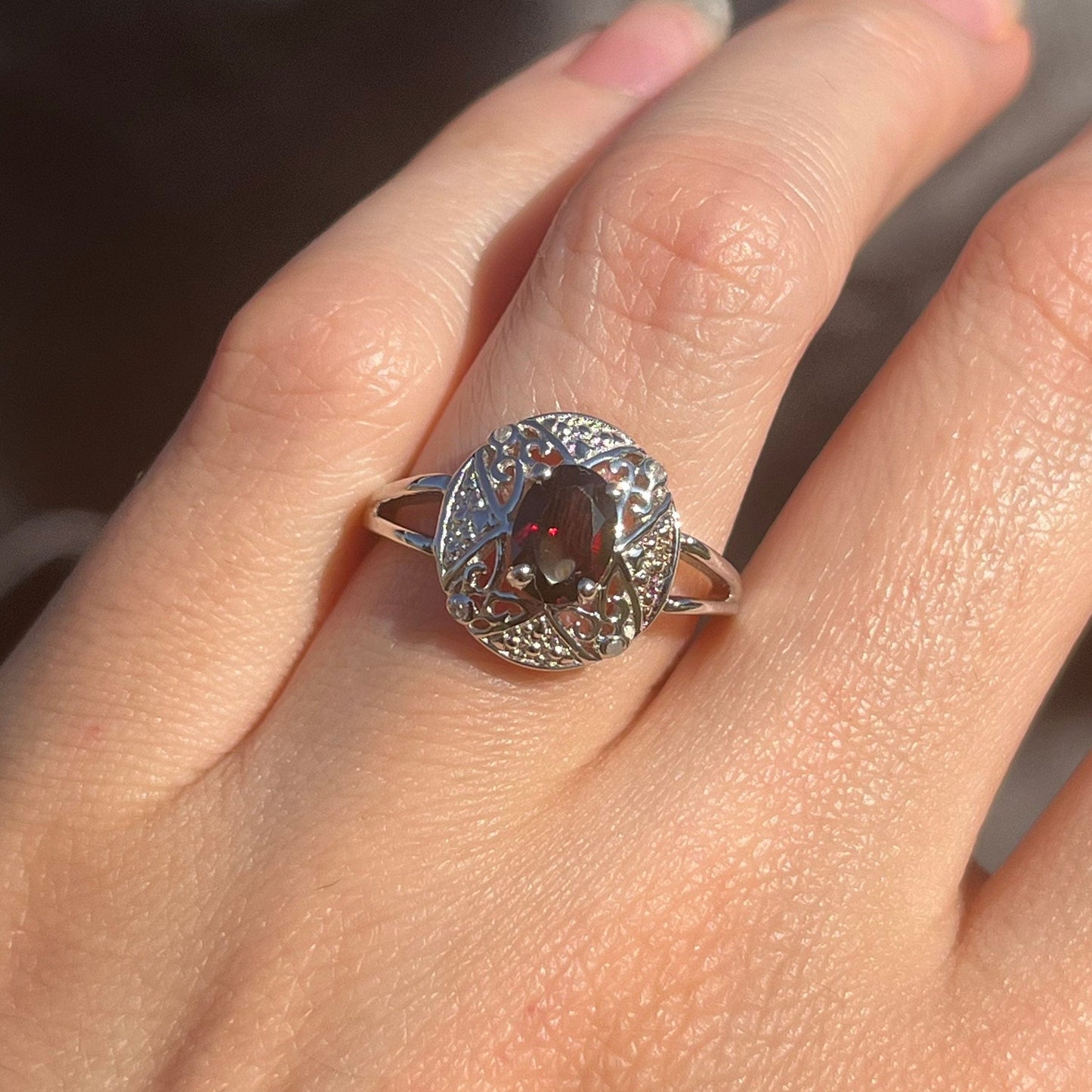 Red Garnet Sterling Silver Ring with diamonds on a hand